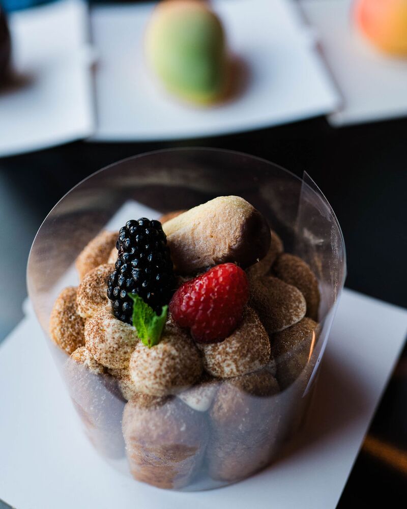Ladyfinger cake topped with a blackberry and strawberry