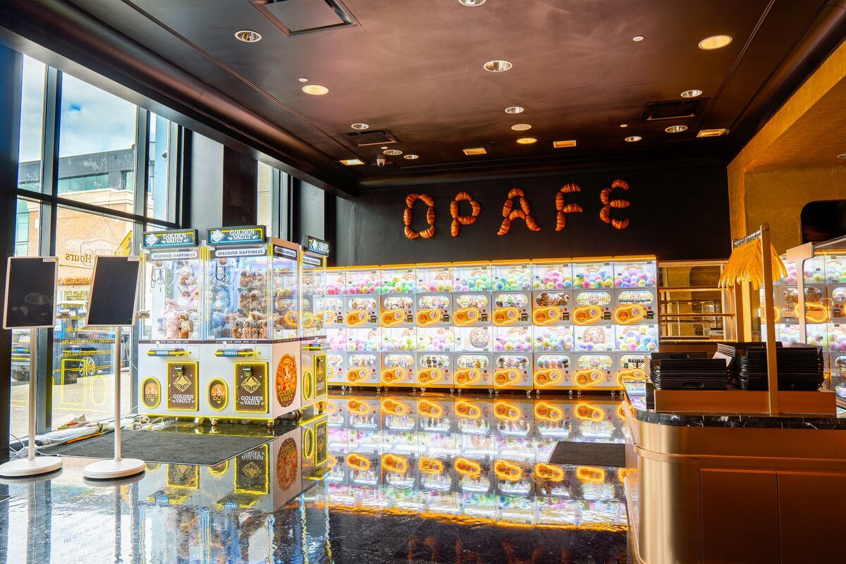 Capsule toy wall and claw machines beneath the OPAFE sign