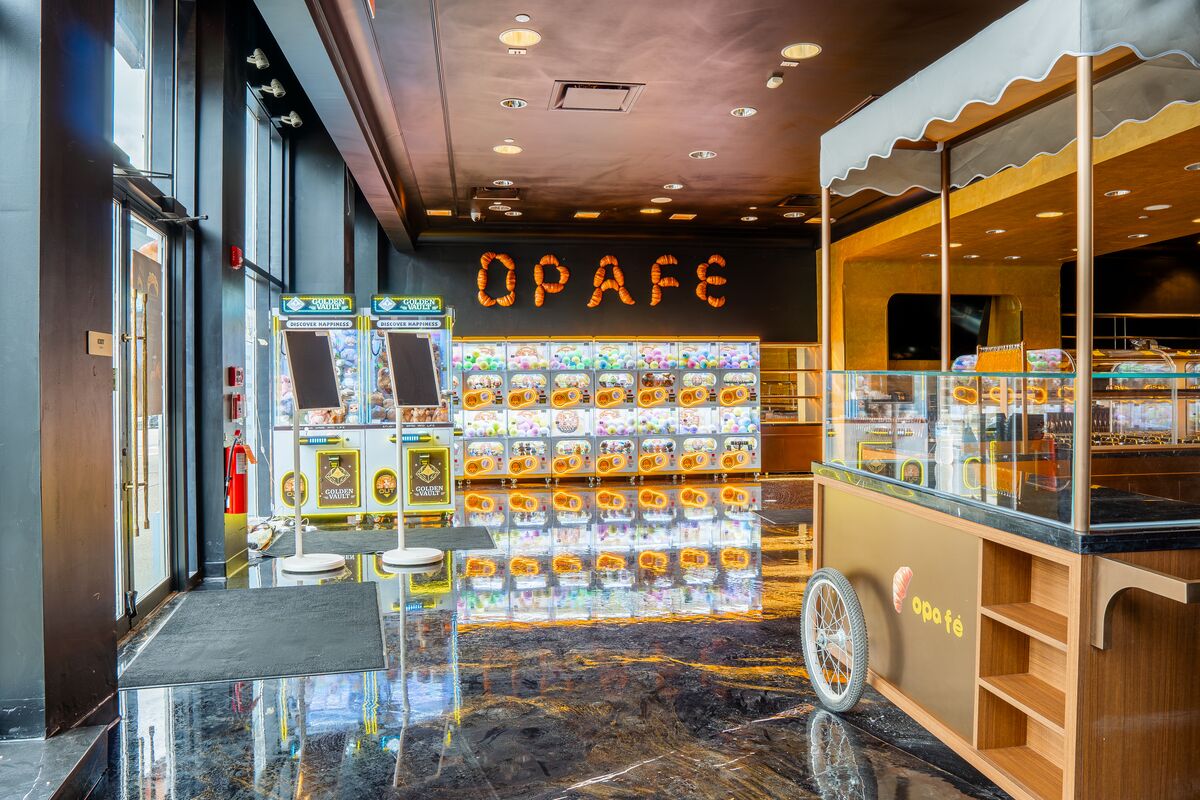 Striped-awning cart in front of the capsule toy wall