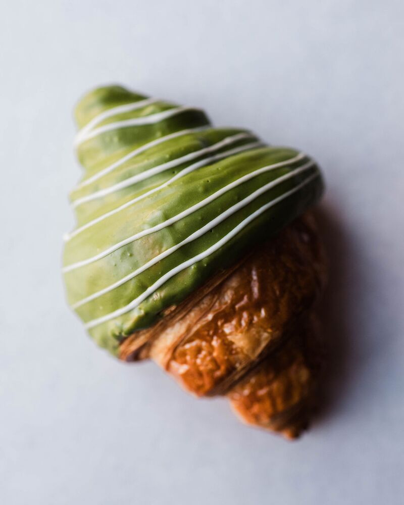 Matcha-glazed croissant with white chocolate stripes