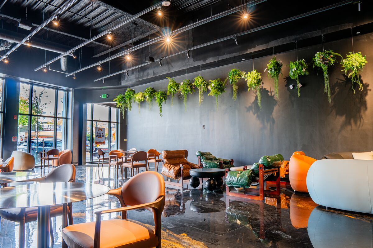 Lounge chairs and café tables along the front windows