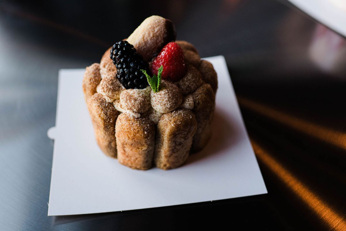 Ladyfinger cake topped with a blackberry and strawberry